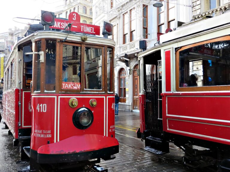 a red train is parked on the side of a building