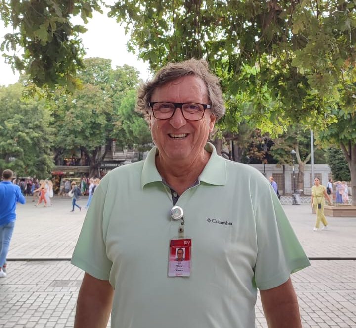 a man standing in front of trees
