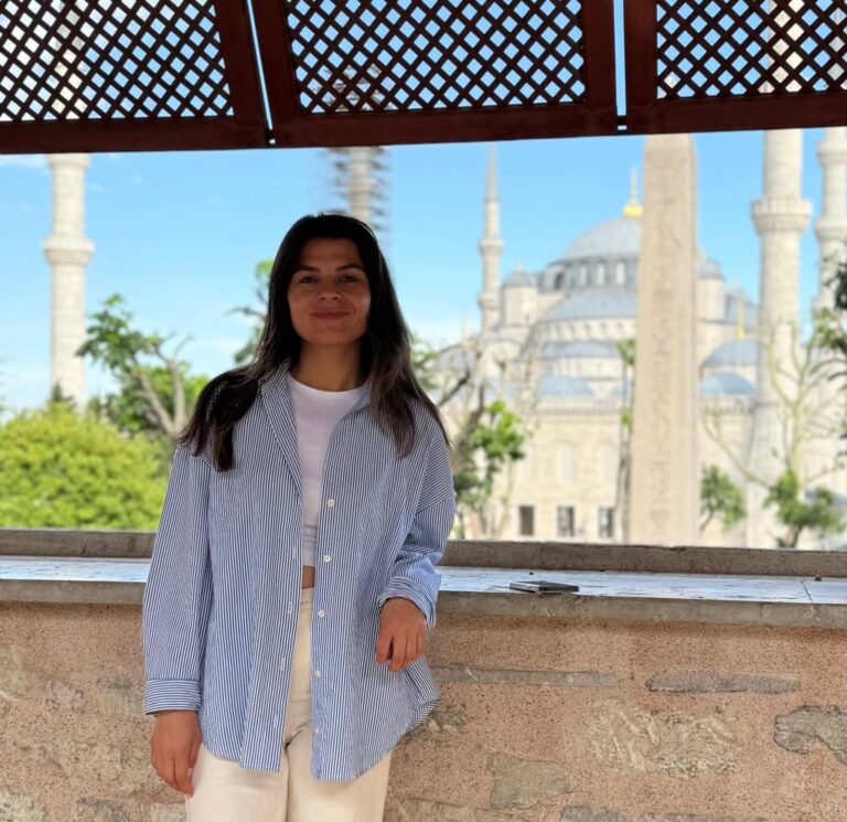 a woman standing in front of a window