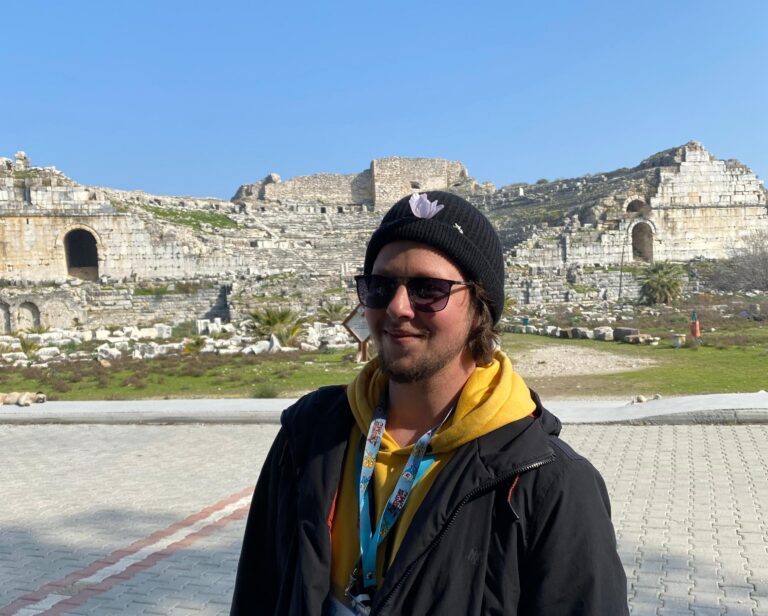 a man standing in front of a mountain