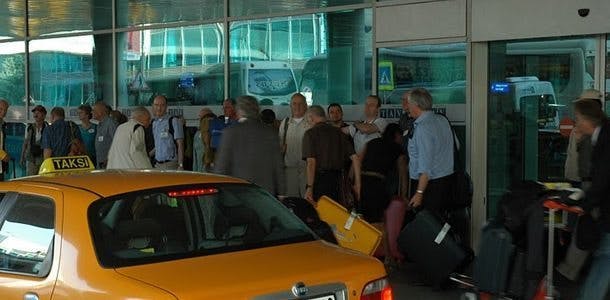 a group of people standing in front of a car