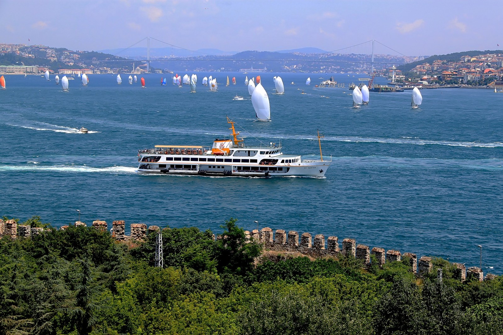 a group of people flying kites in a large body of water