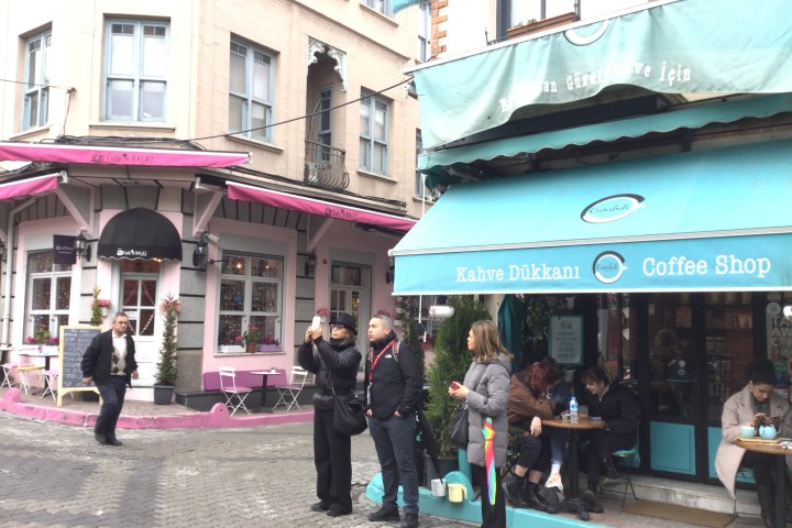 a group of people walking in front of a building