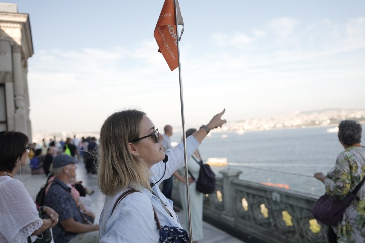 a group of people looking at a cell phone