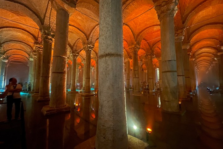 a large building with Basilica Cistern in the background