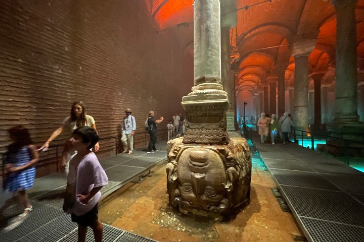 a group of people walking on a sidewalk