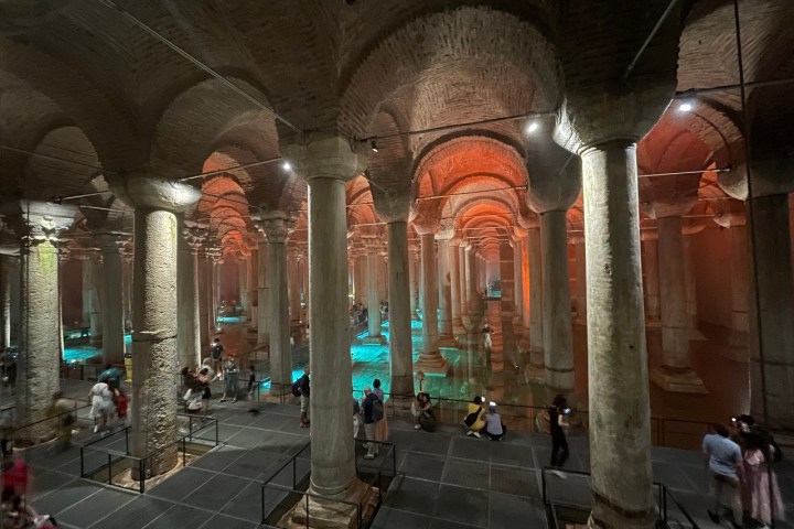 a group of people on a sidewalk in front of a building