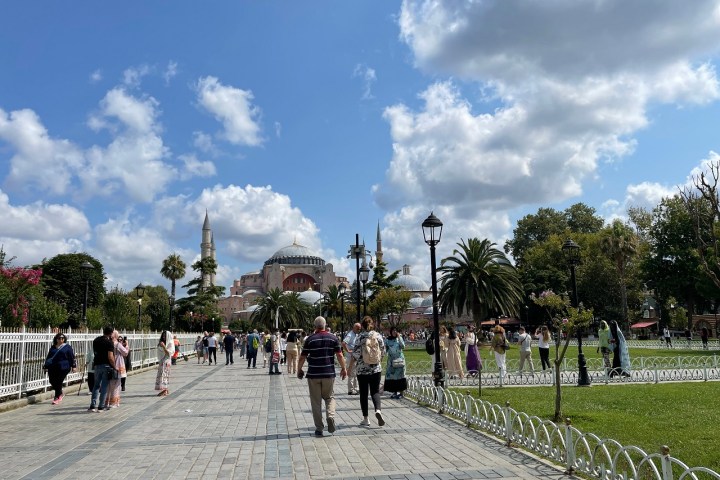 a group of people walking on a cloudy day