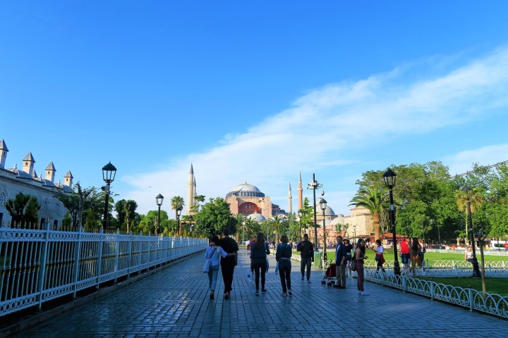 a group of people walking on a bridge