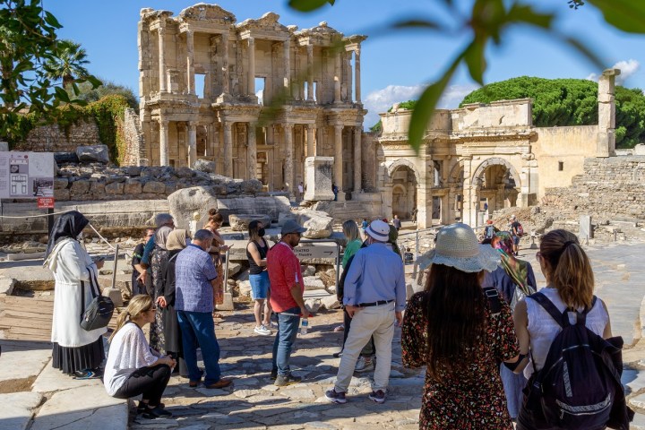 a group of people walking in front of a building
