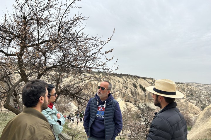 a group of people standing in the grass