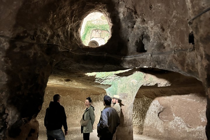 a group of people standing on top of a mountain