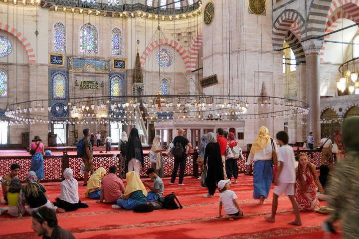 a group of people sitting in front of a building
