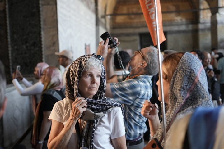 a group of people looking at a cell phone